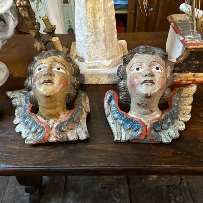 a pair of 1750s baroque lacquered wood sculptures of angel heads with wings 5545