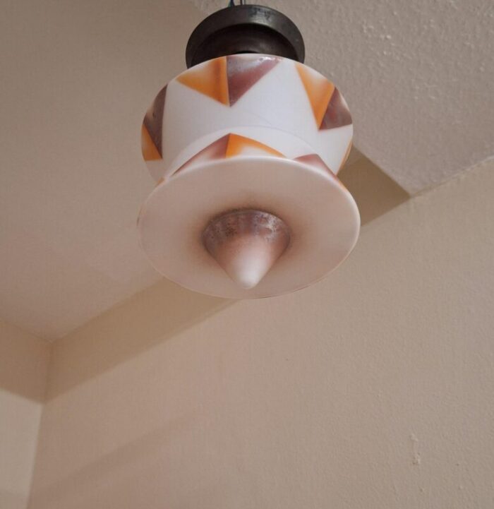 art deco german ceiling lamp with white glass shade with an orange brown spray decorative motif on an original brass mount 1645