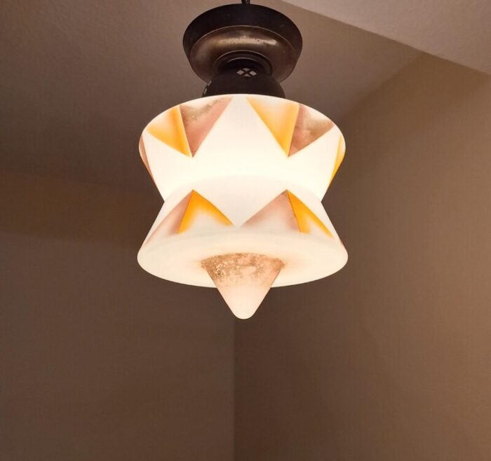 art deco german ceiling lamp with white glass shade with an orange brown spray decorative motif on an original brass mount 2209